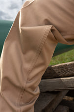 Close-up of the triple-stitched seams on the thigh and knee of the khaki FR COOLBACKS® Work Pants