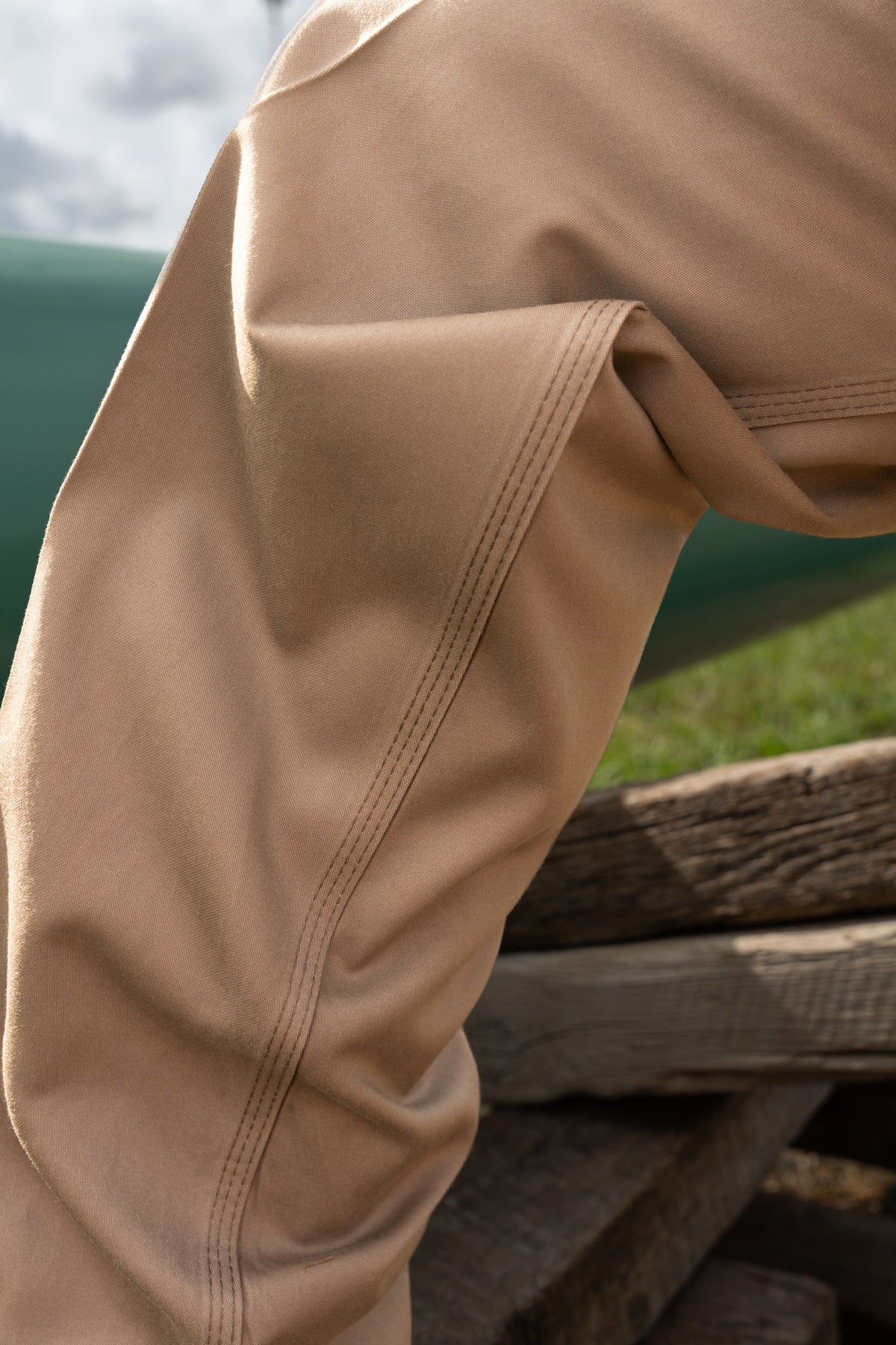 Close-up of the triple-stitched seams on the thigh and knee of the khaki FR COOLBACKS® Work Pants