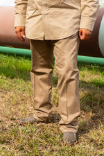 FR COOLBACKS® Work Pants in khaki, front view worn with western boots at a pipeline job site